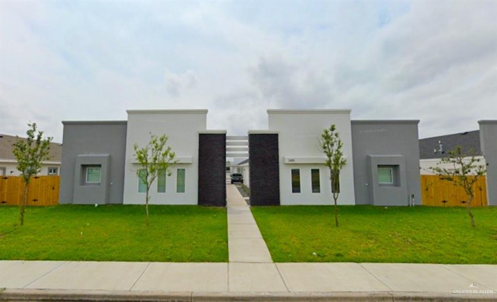 a picture of a house with a yard and a garden