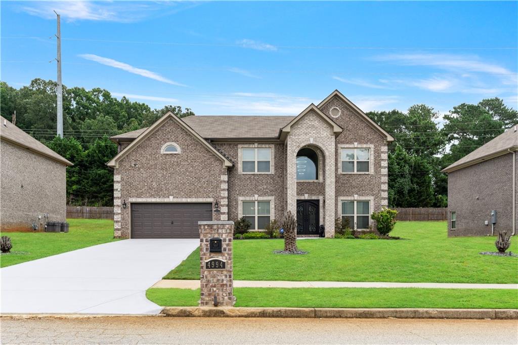 a front view of a house with a yard