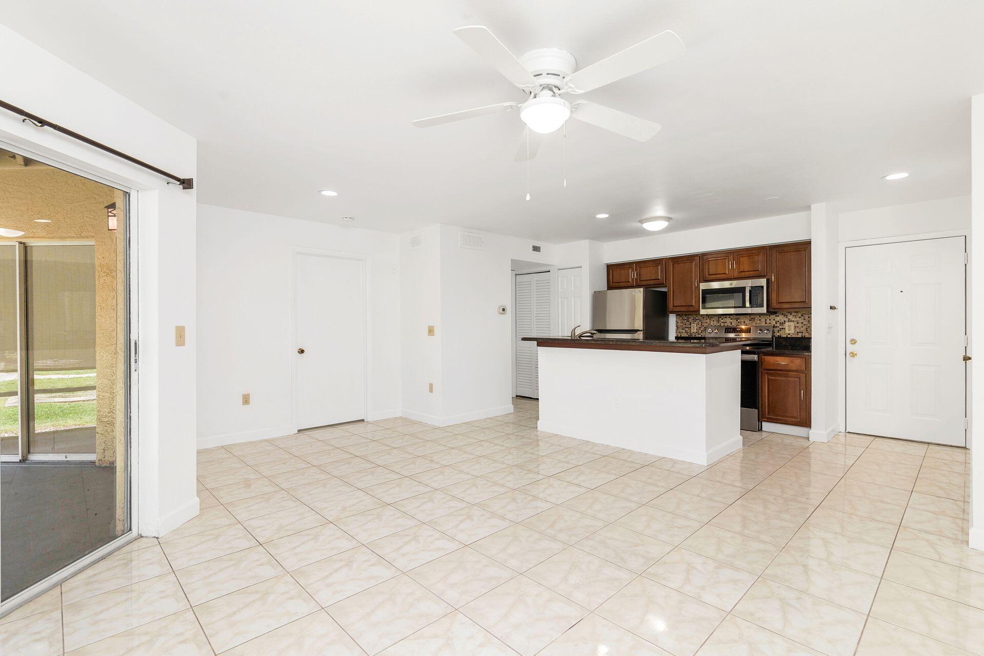 a view of kitchen with granite countertop cabinets and stainless steel appliances