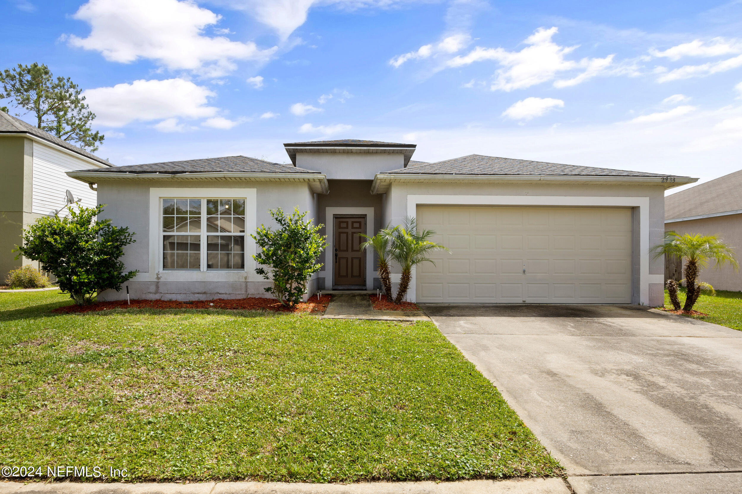 a front view of a house with garden