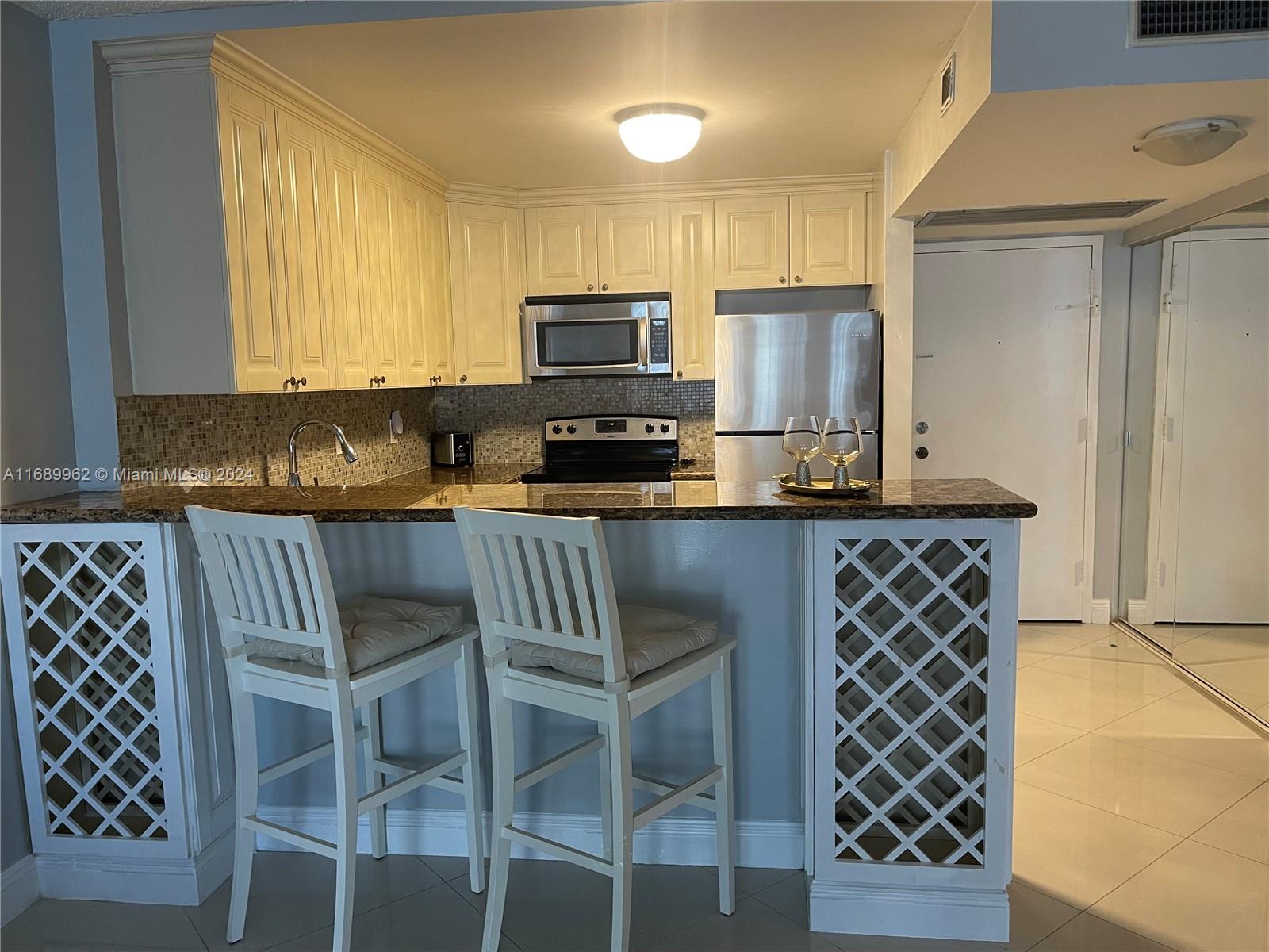 a kitchen with granite countertop a sink and cabinets