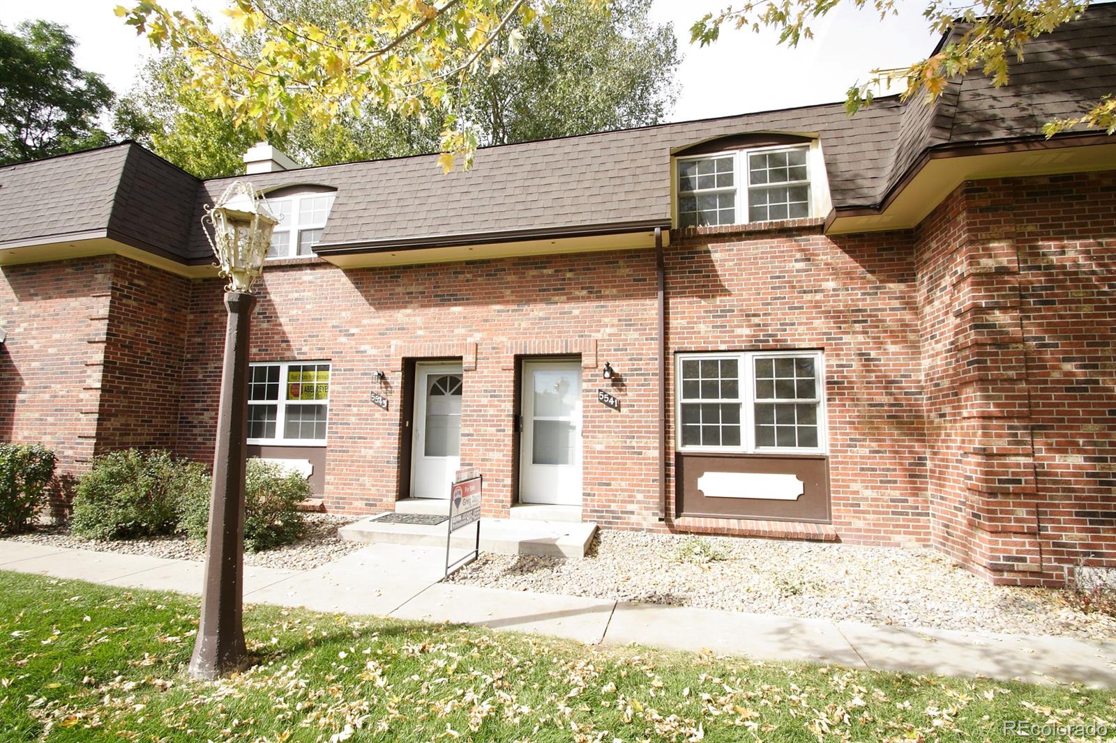 a view of a house with a yard and sitting area