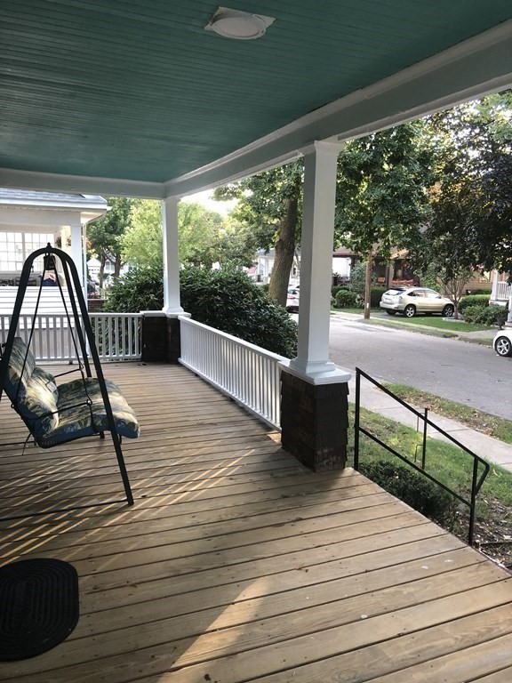 a view of a balcony with wooden floor