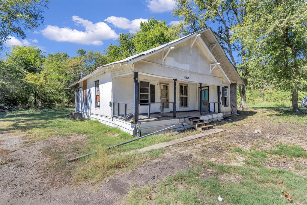 a view of a house with backyard and chairs