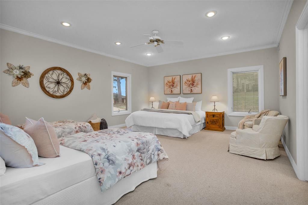 Spacious bedroom with LAKE VIEWS!!   Queen bed on one side with a sitting area and twin beds on the other side of the room.  There's still tons of room ihis space along with an ensuite bath and large walk-in closet.