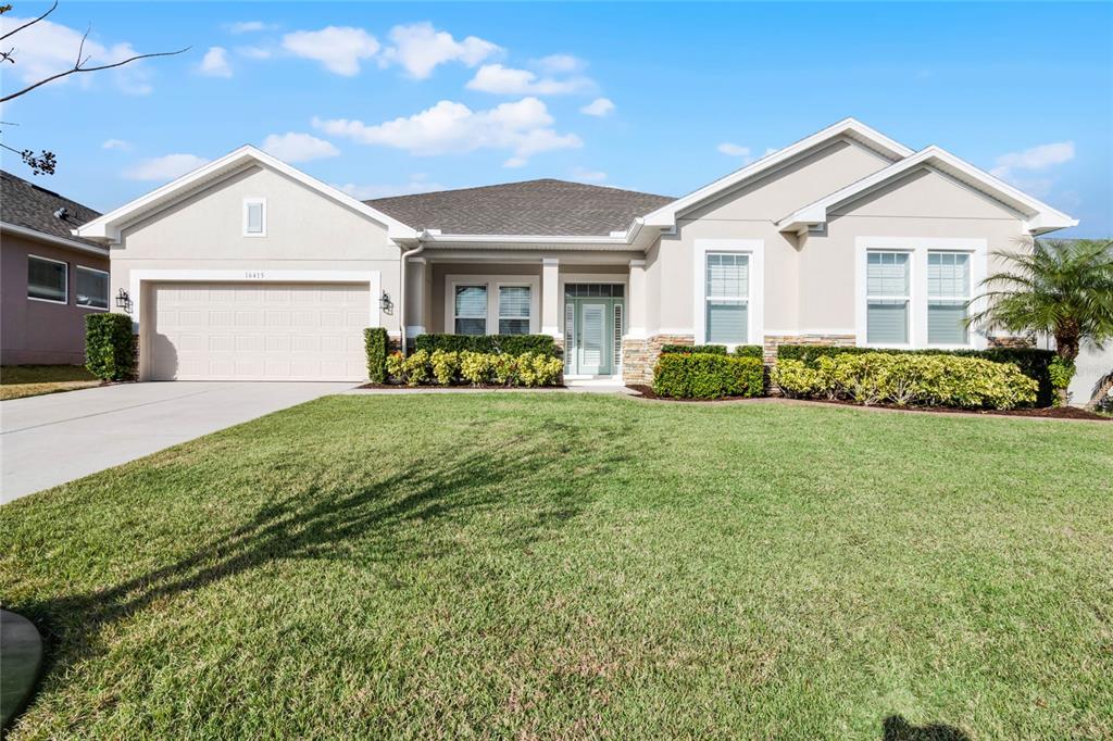 a front view of a house with a yard and garage