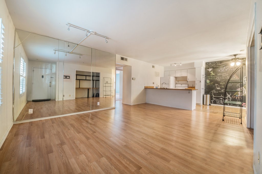 a view of a kitchen with wooden floor and a kitchen