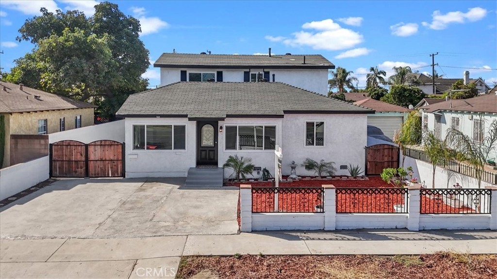 a front view of a house with yard and sitting area