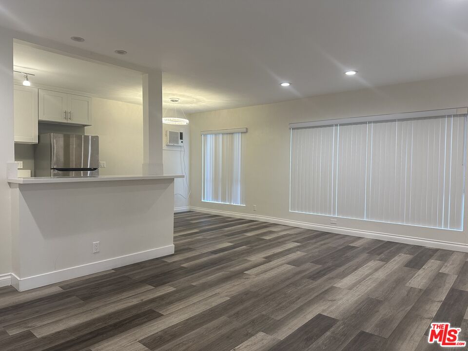 a view of a kitchen cabinets and a wooden floor