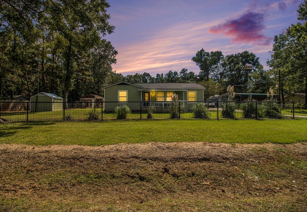 a front view of house with yard and green space