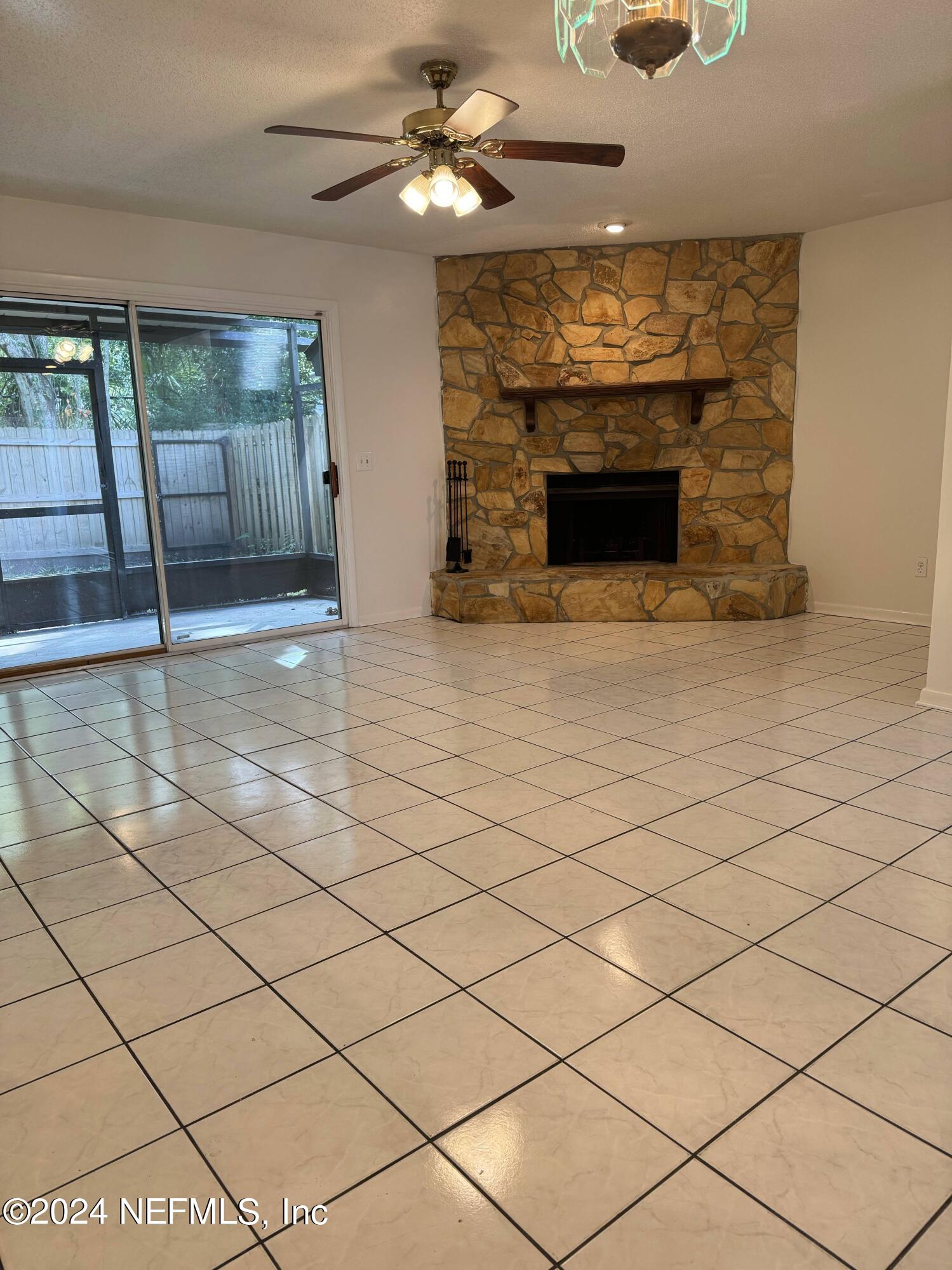 a view of an empty room with a fireplace