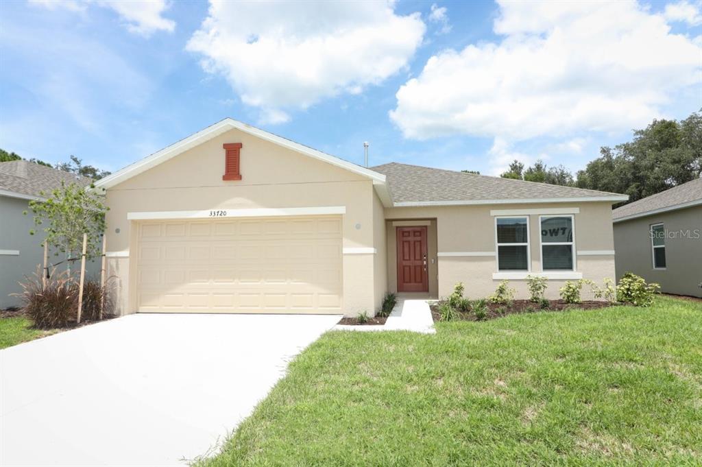 a front view of a house with yard