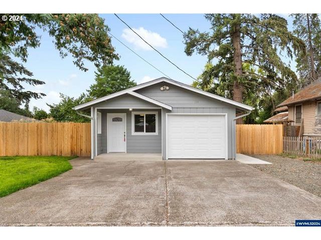 a view of a house with a yard and garage