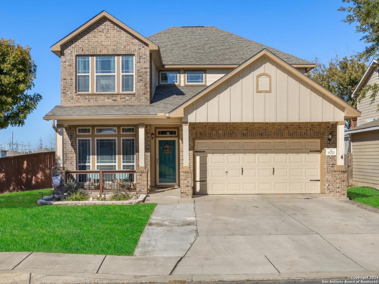 a front view of a house with a yard and garage