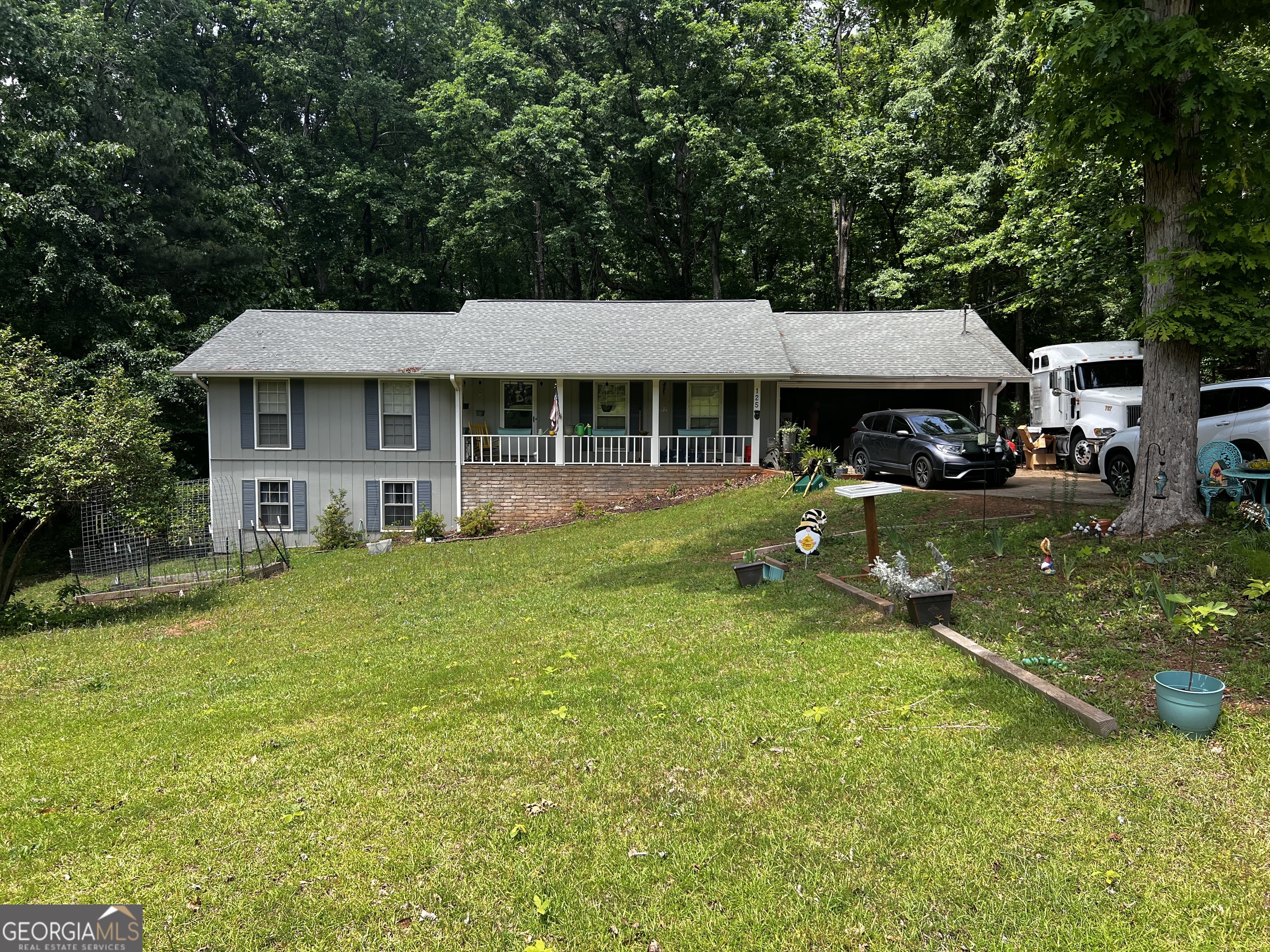 a view of a house with a yard porch and sitting area