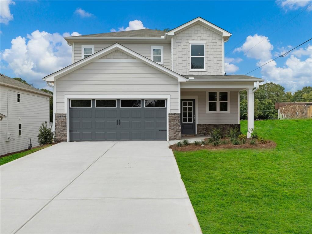 a front view of a house with a yard and garage