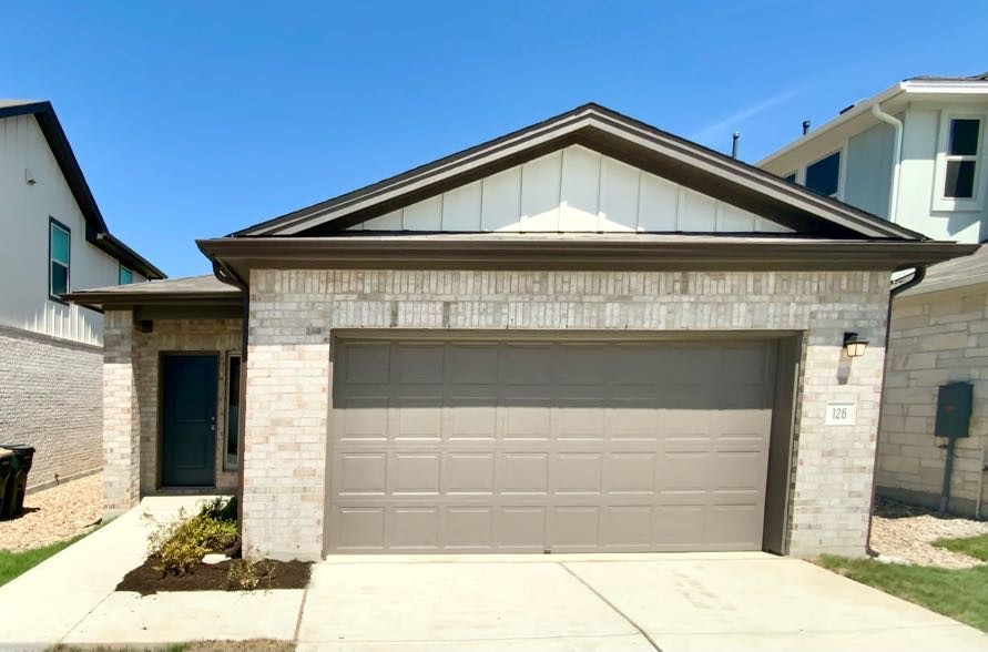 a front view of a house with a garage