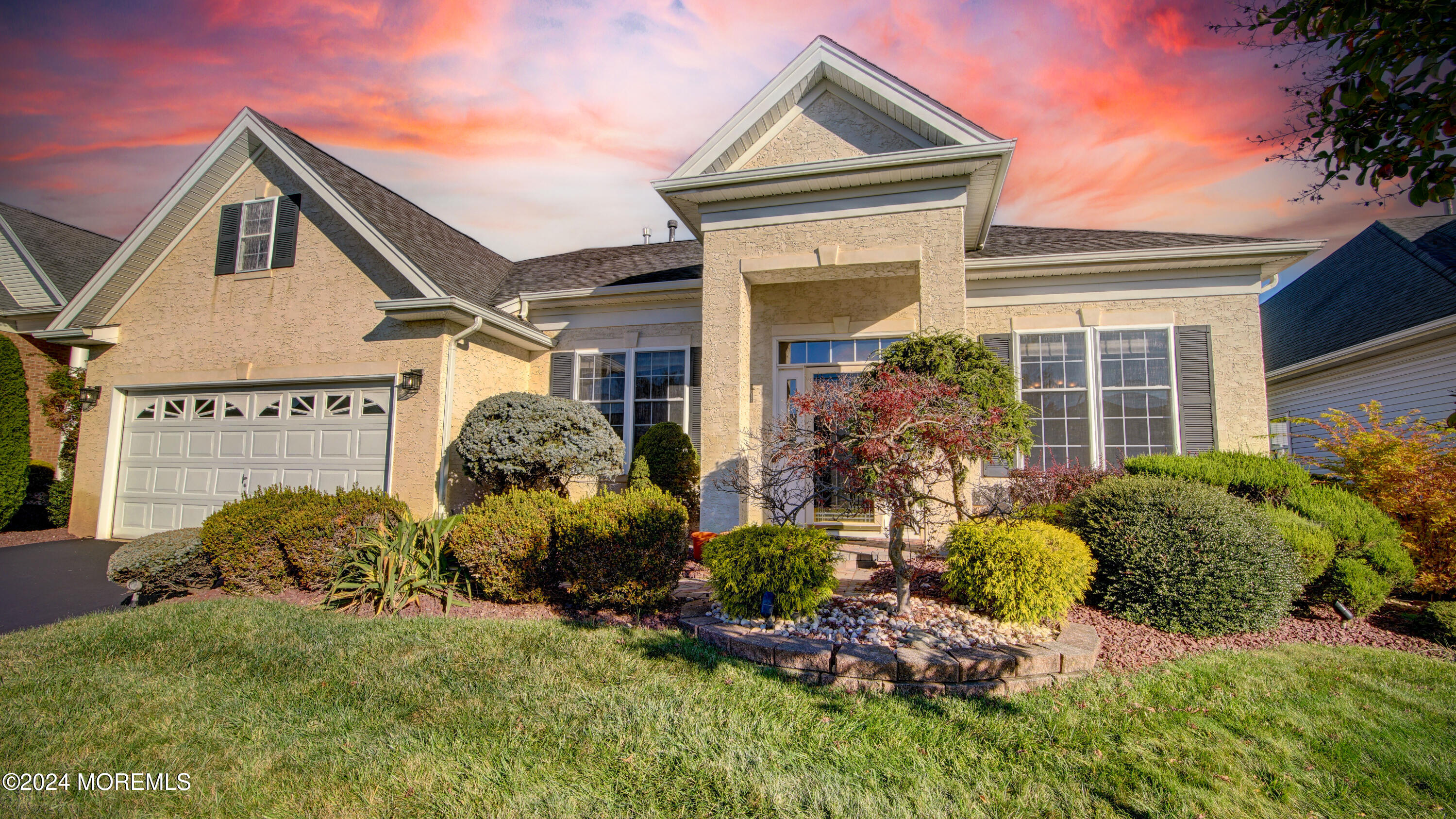 a front view of a house with a garden