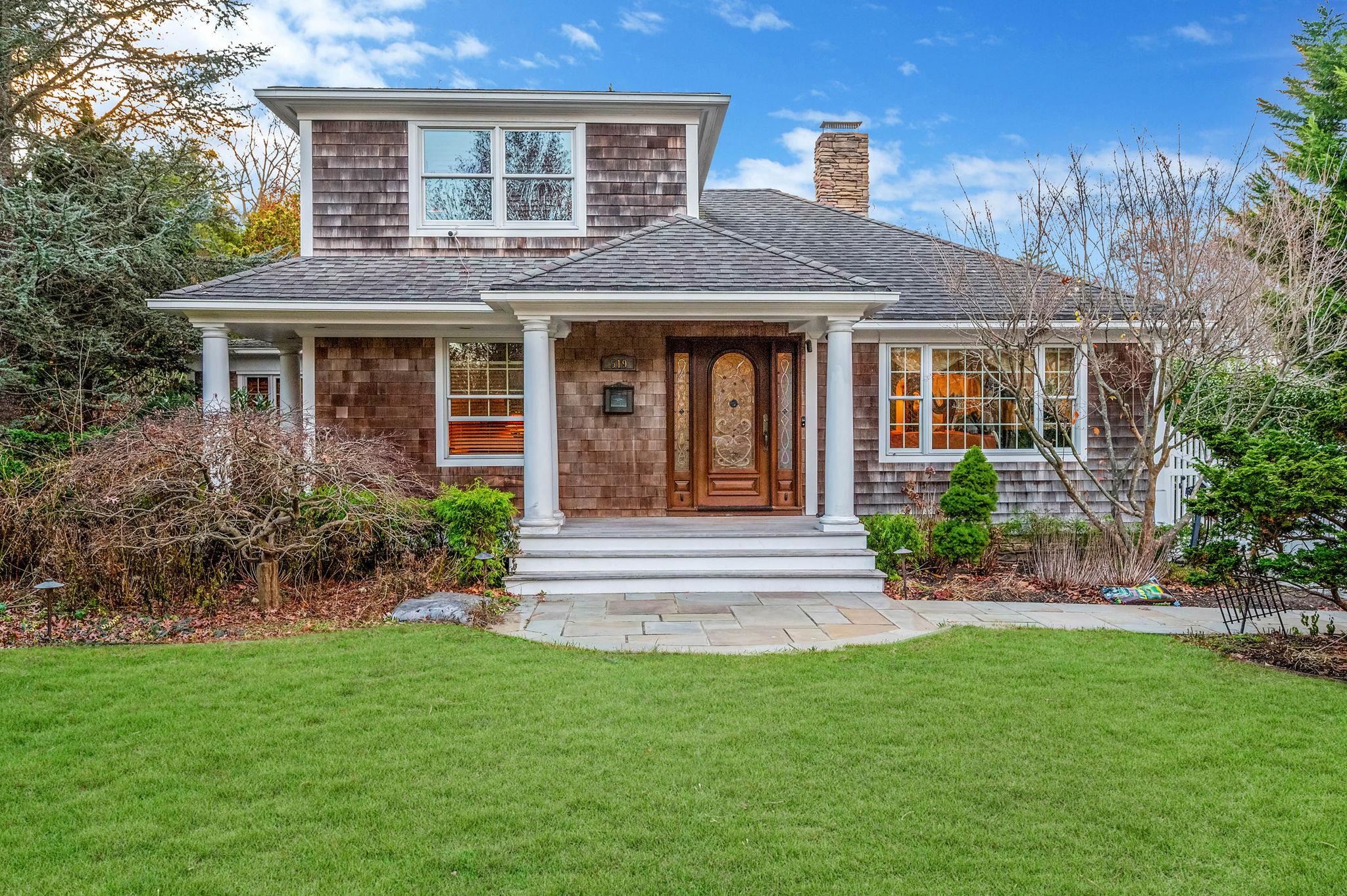 a front view of a house with a garden