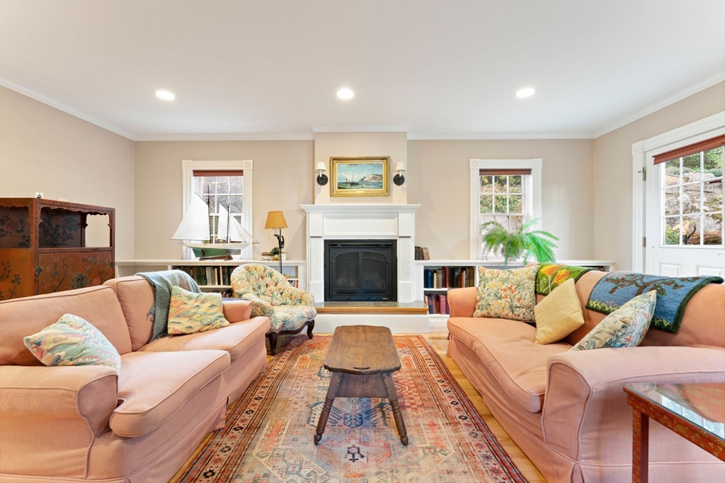 a living room with furniture a rug and a fireplace