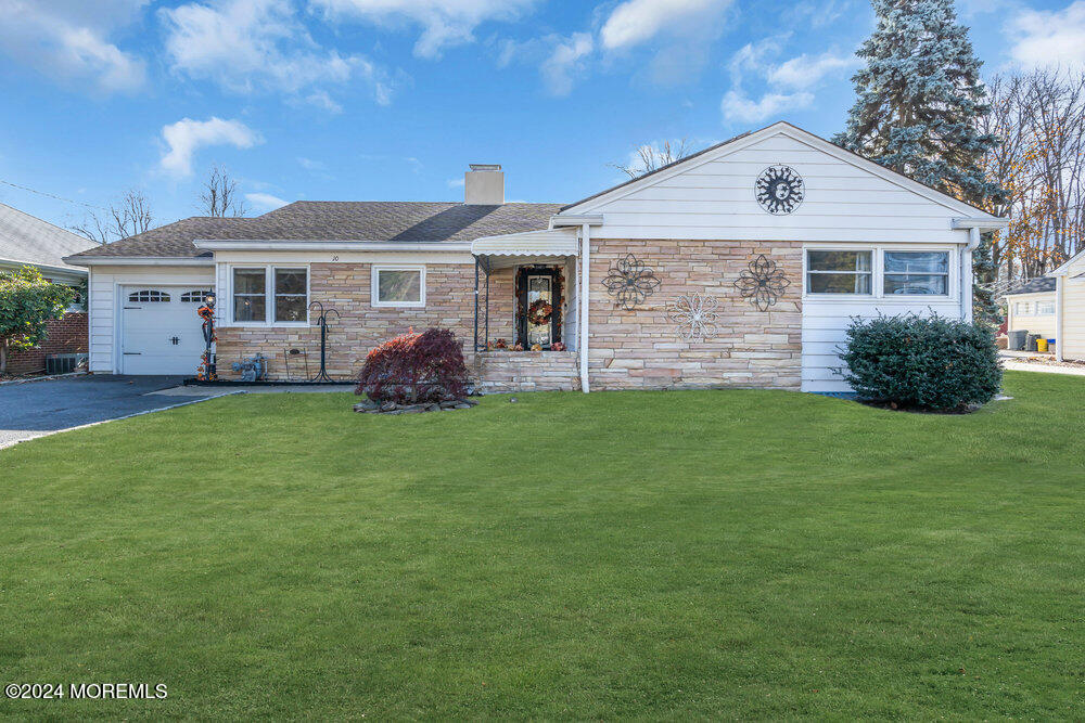 a front view of a house with a garden and yard