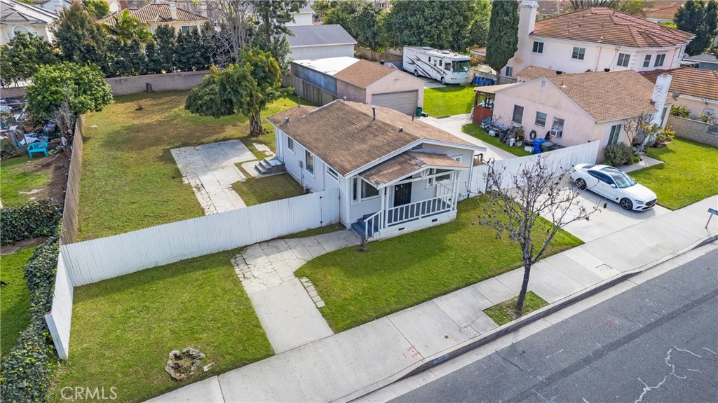 an aerial view of a house with a garden and a large tree