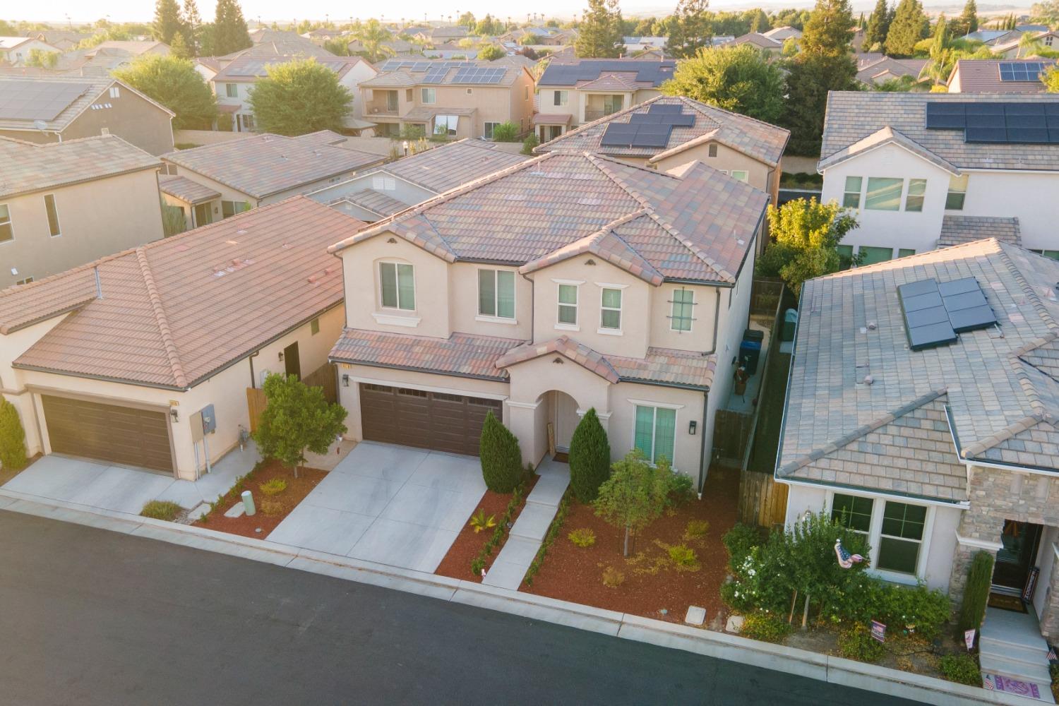 an aerial view of residential houses with yard