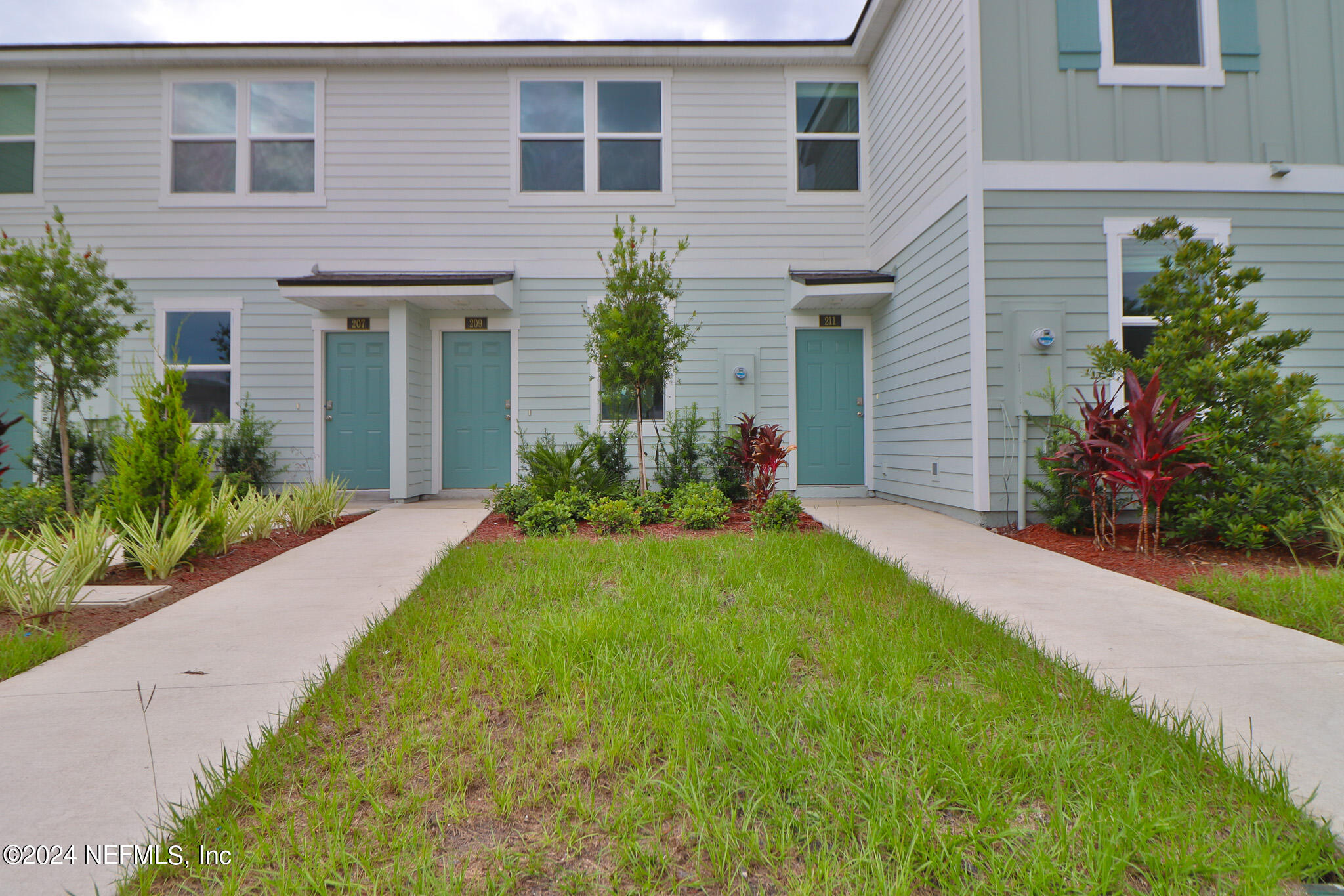 a front view of a house with a garden