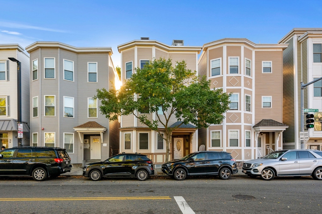 a front view of a residential apartment building with a yard