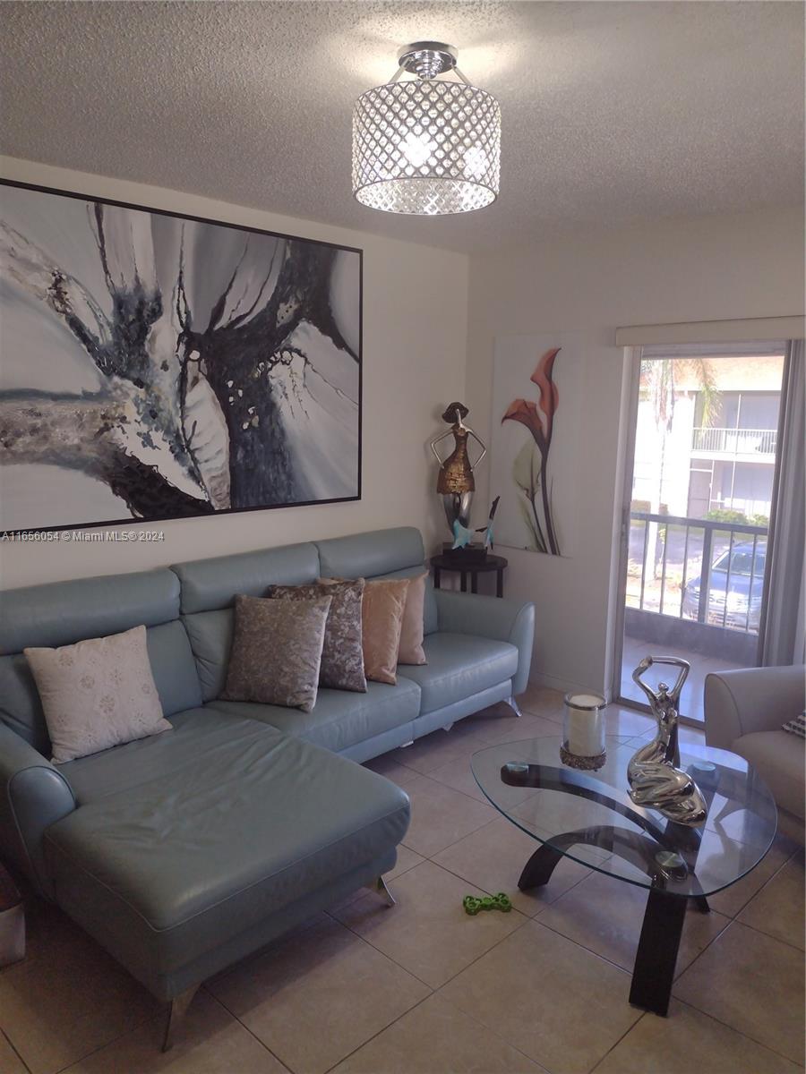 a living room with furniture chess board and a window