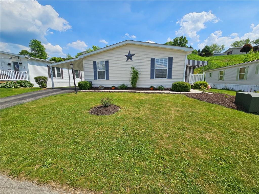 a view of a house with a yard and a patio