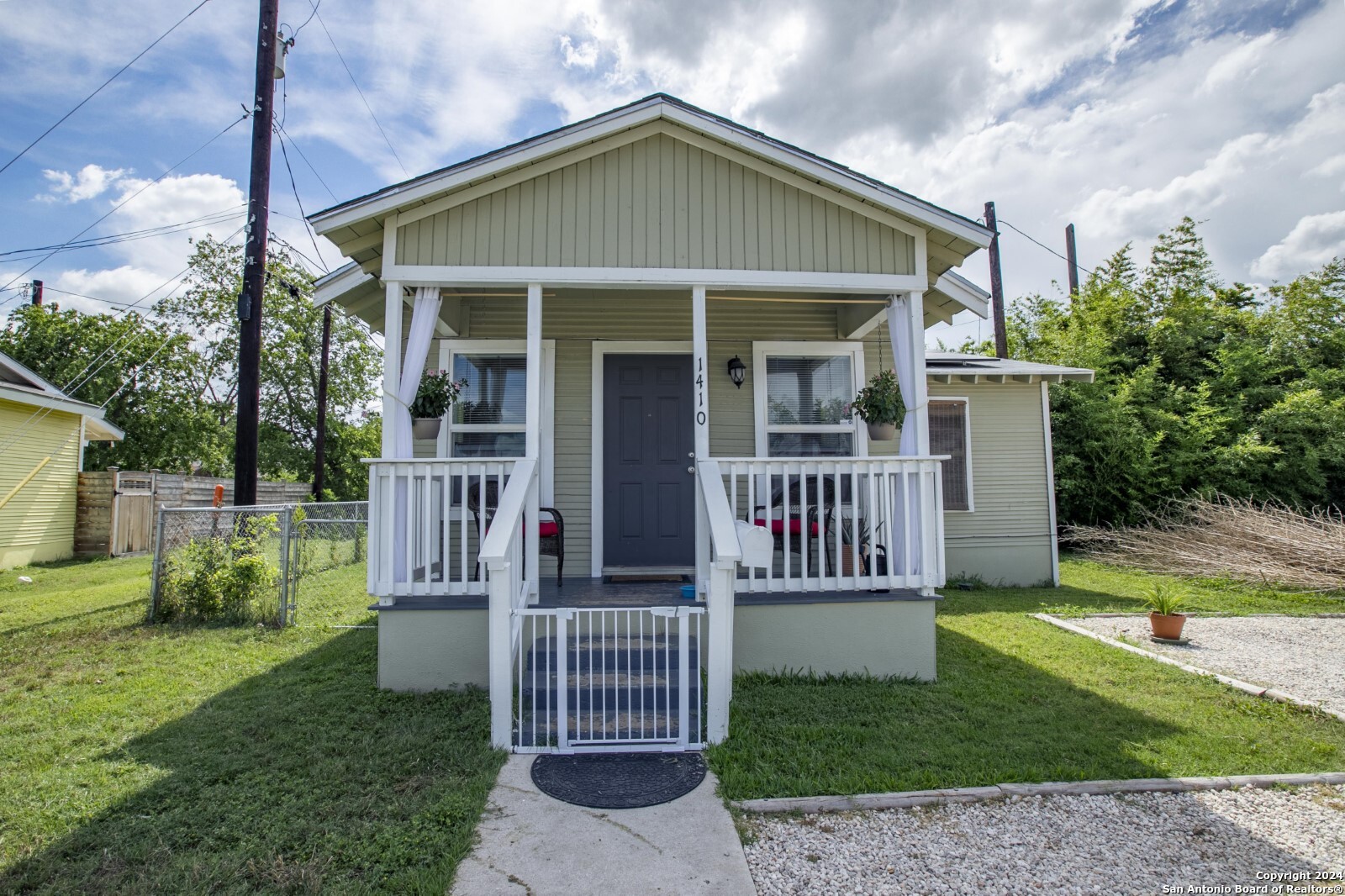 a front view of a house with a garden