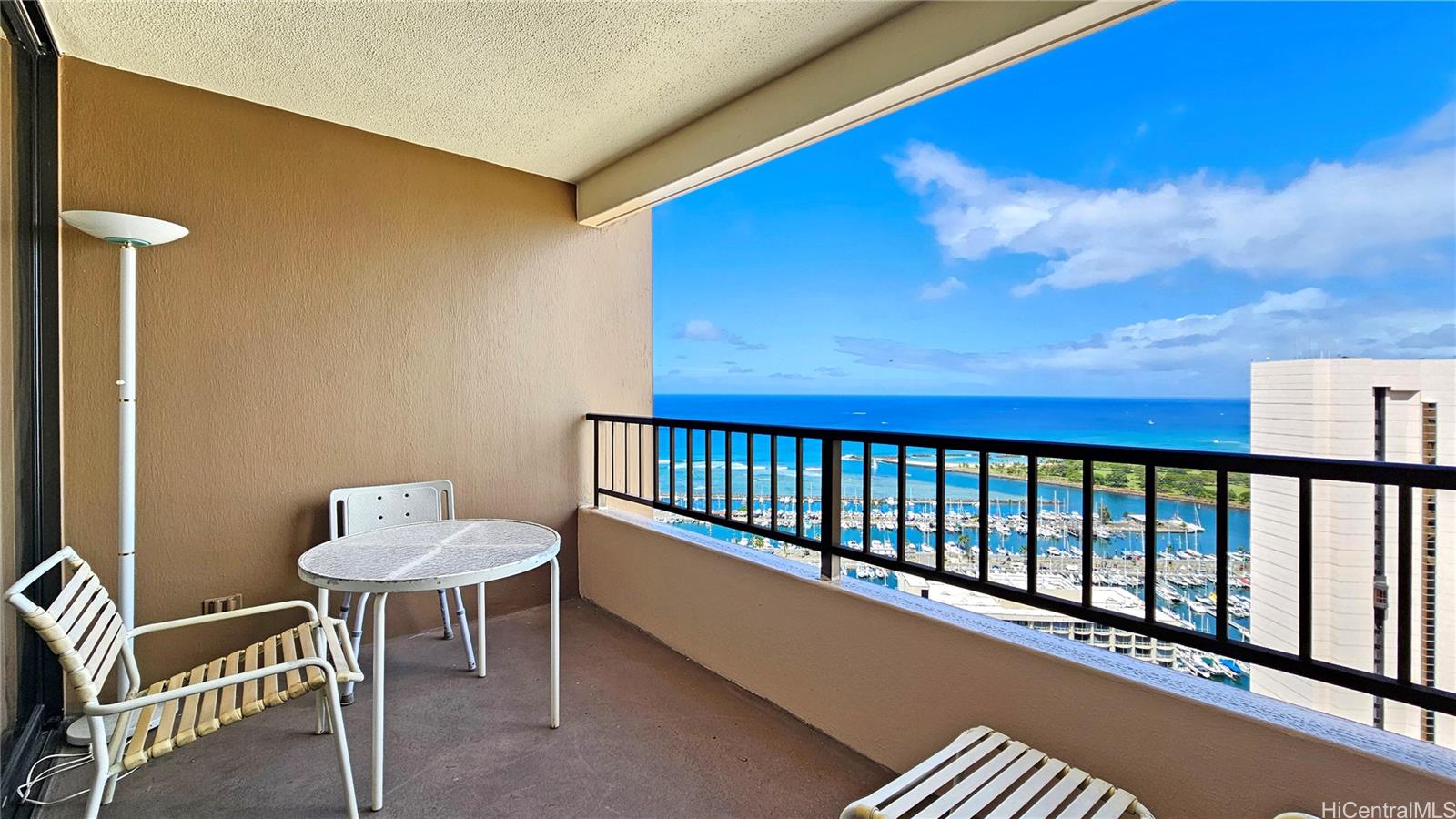 a balcony with table and chairs