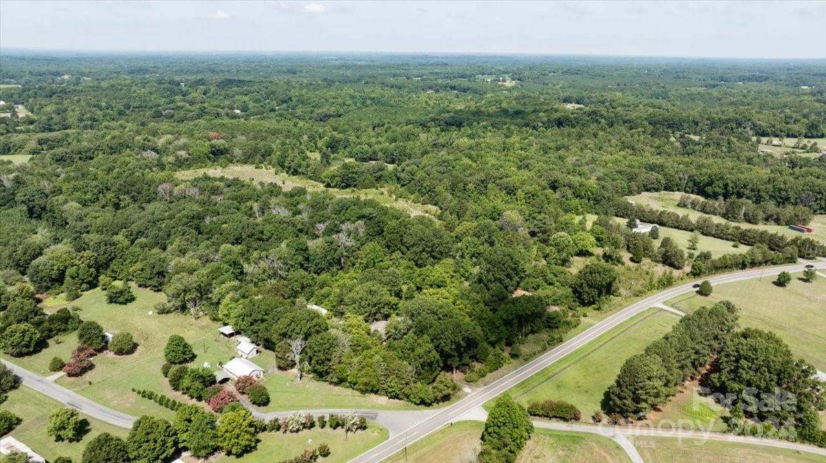 a view of a green field with lots of bushes