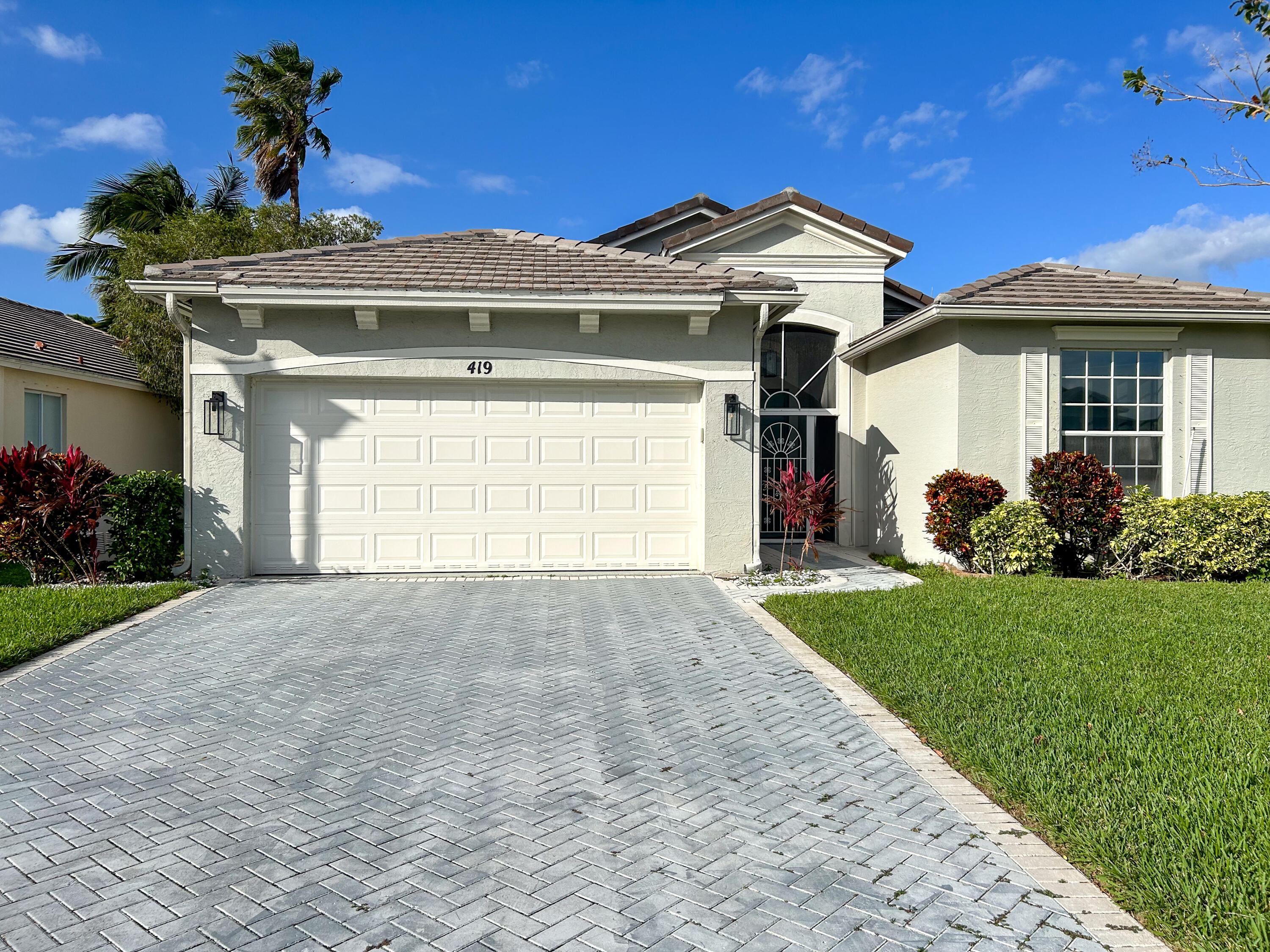 a front view of a house with a yard and garage