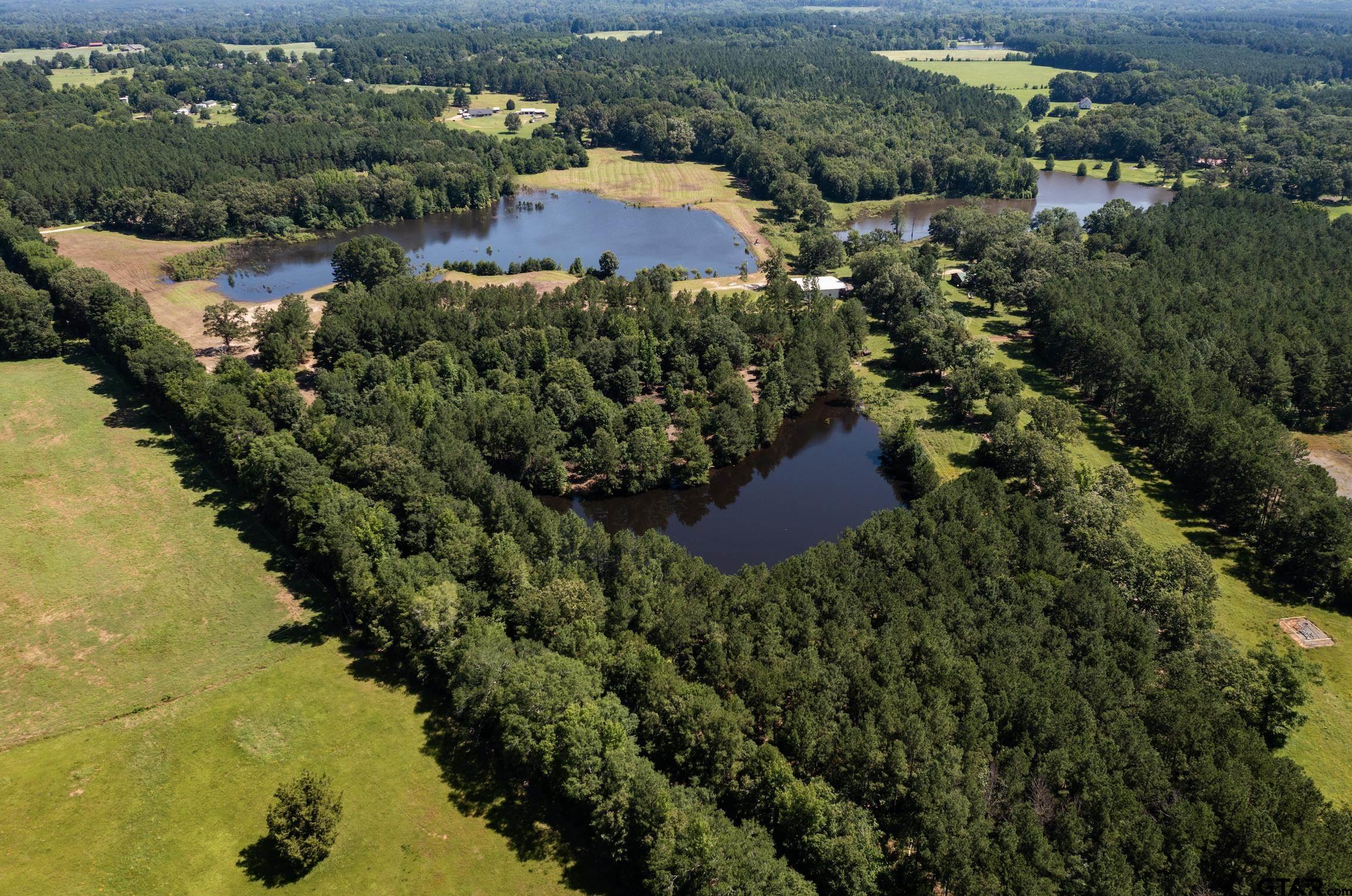 an aerial view of house with yard and swimming pool