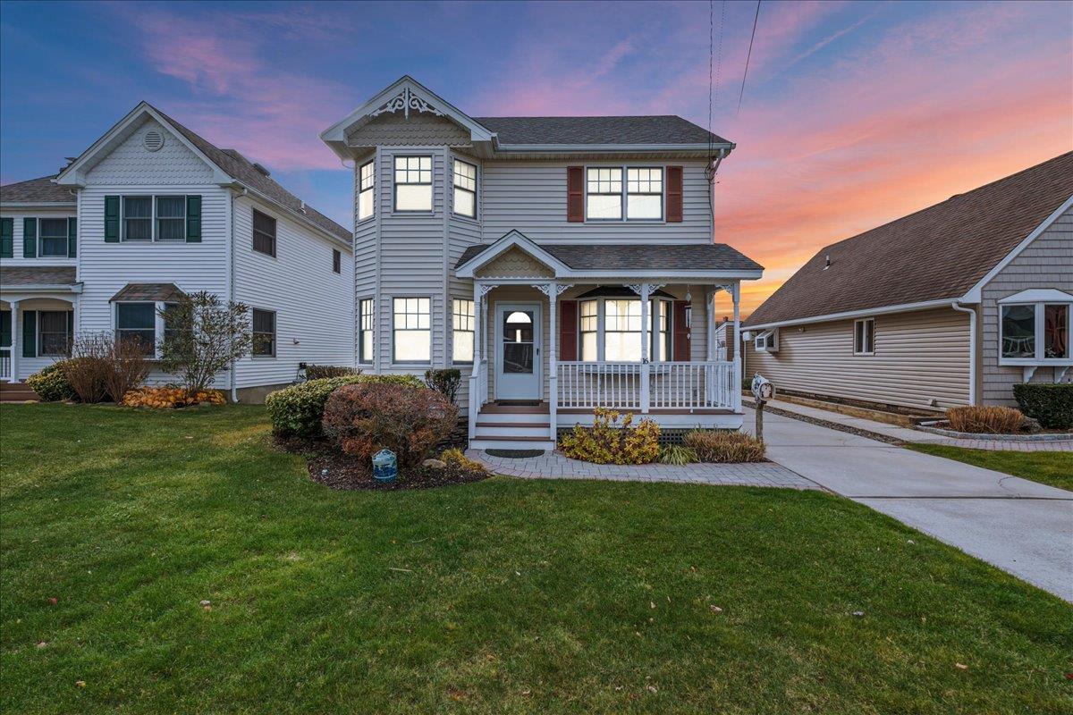 a front view of a house with a garden and deck