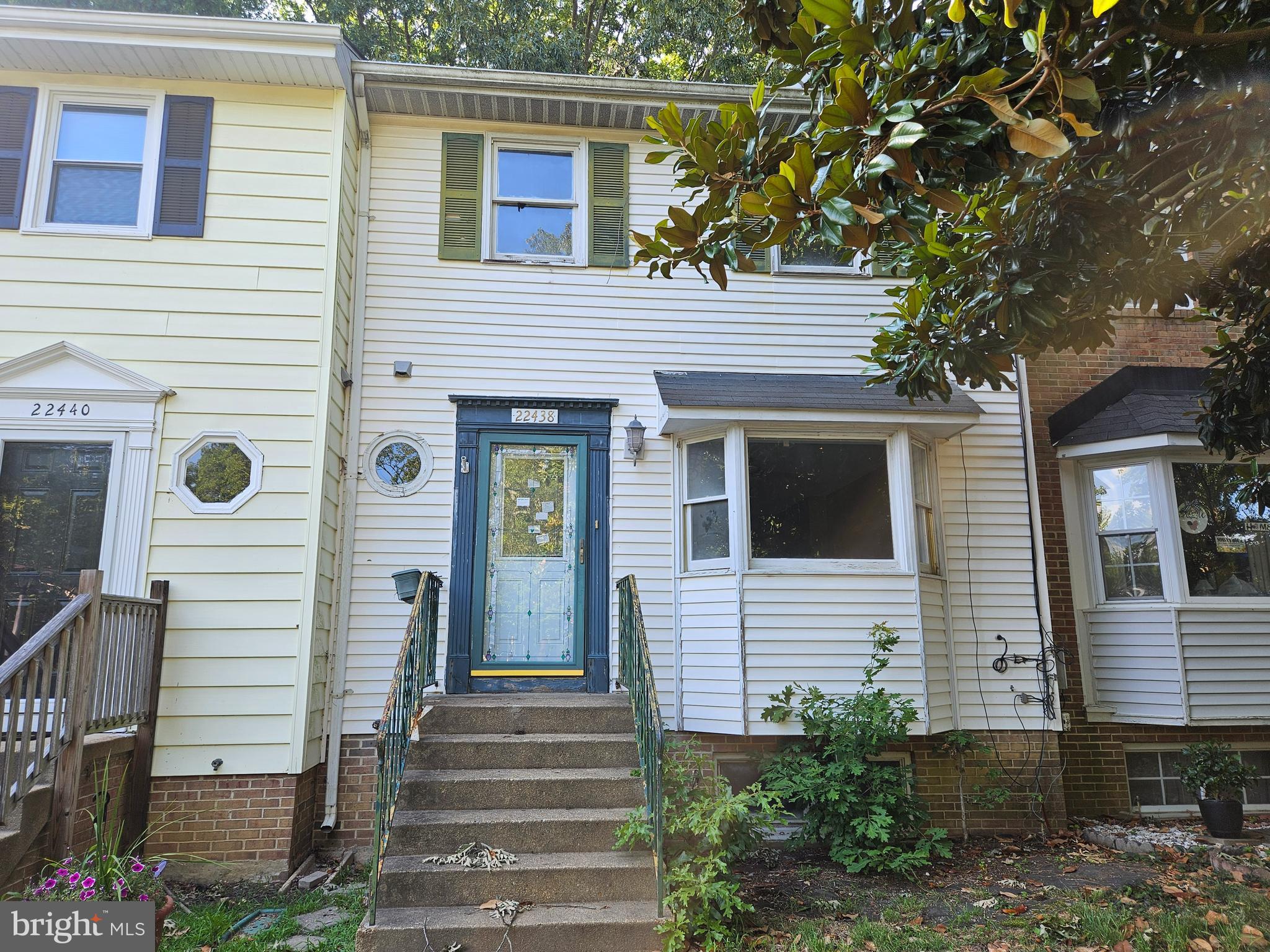 a view of a house with a white door and stairs