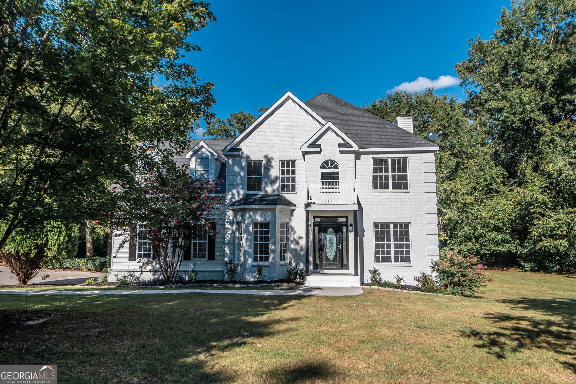 a front view of a house with a yard