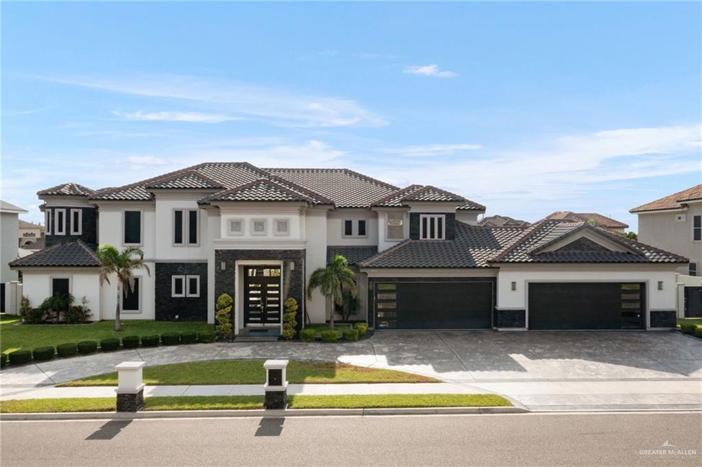 a front view of a house with a garden and yard