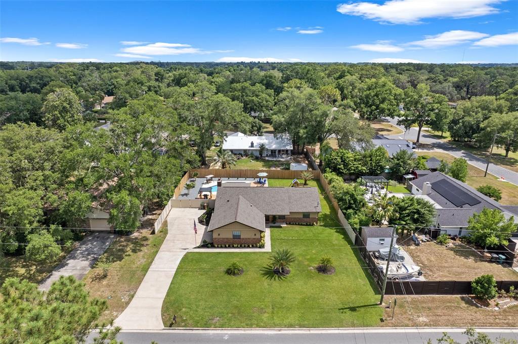 an aerial view of a house with a yard