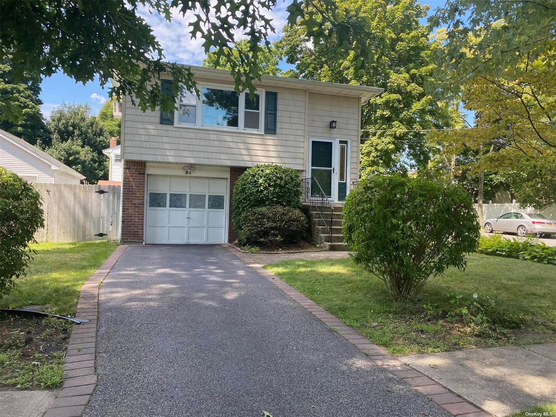 a front view of a house with a yard and a garage