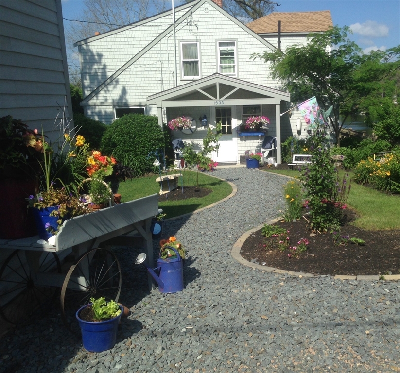 a front view of a house with yard and sitting area