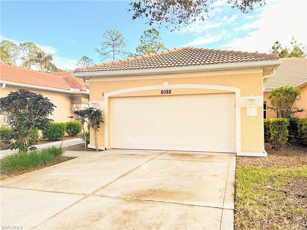 Mediterranean / spanish-style house with a garage