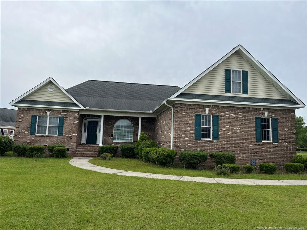 a front view of a house with garden