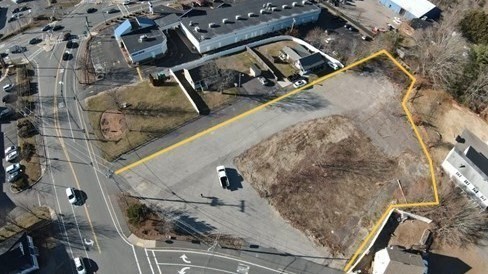 an aerial view of a backyard with wooden fence