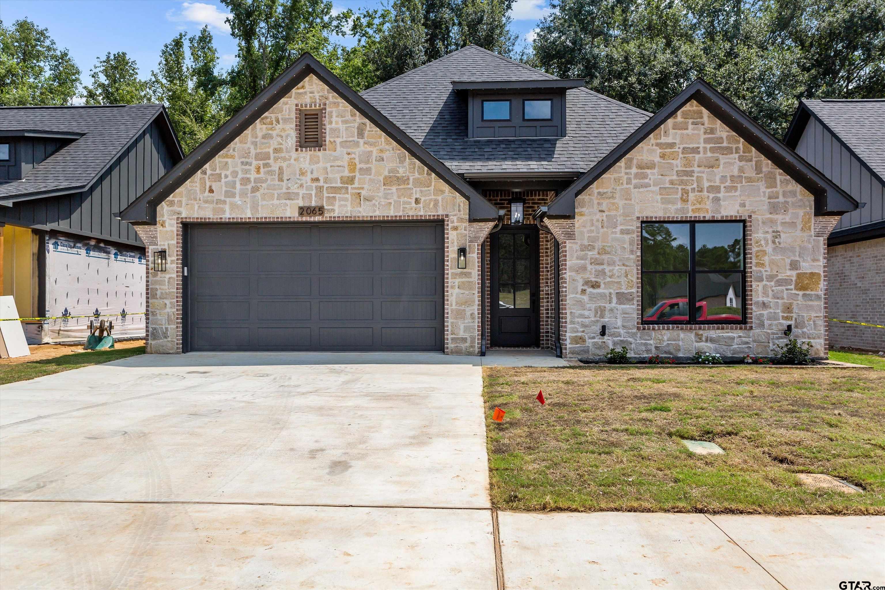 a front view of a house with garage