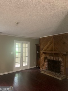 a view of empty room with wooden floor and fireplace