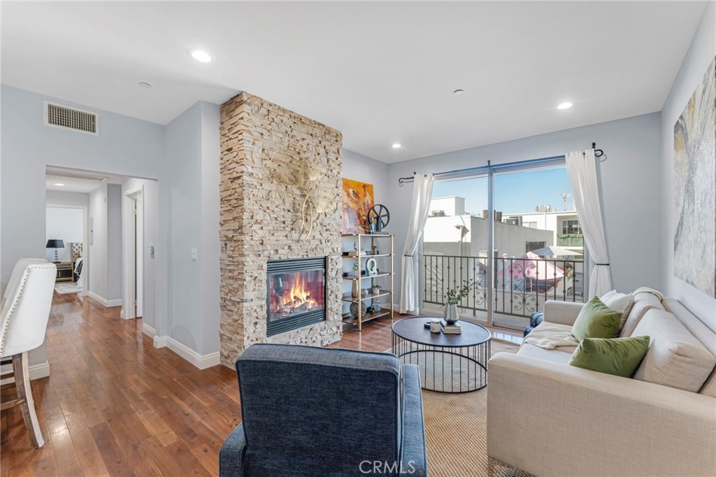 a living room with furniture a fireplace and a chandelier