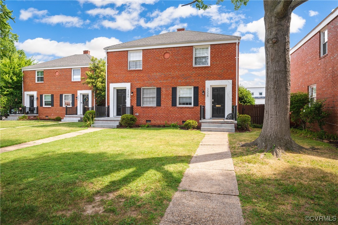 a front view of a brick house with a yard